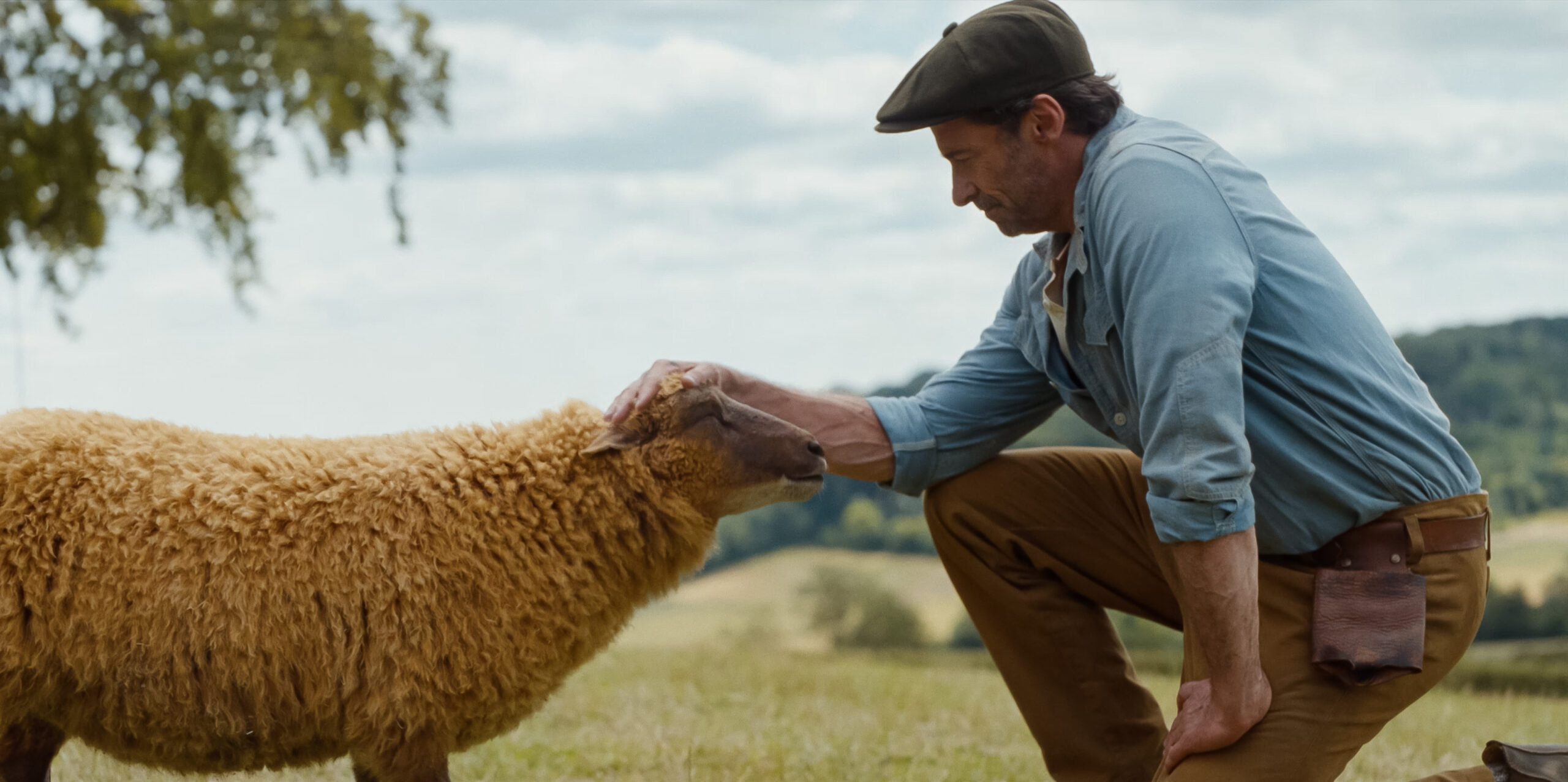 (L to R) Julia-Louis Dreyfus as the voice of Lily, the sheep, and Hugh Jackman as George Hardy in THE SHEEP DETECTIVES, from Amazon MGM Studios.Photo credit: Courtesy of Amazon MGM Studios© 2025 Amazon Content Services LLC. All Rights Reserved.