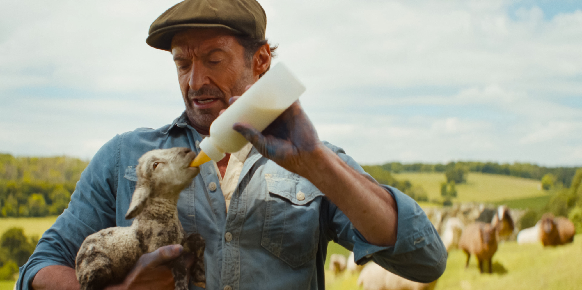 (L to R) Tommy Birchall as the voice of The Winter Lamb and Hugh Jackman as George Hardy in THE SHEEP DETECTIVES, from Amazon MGM Studios.Photo credit: Courtesy of Amazon MGM Studios© 2026 Amazon Content Services LLC. All Rights Reserved.
